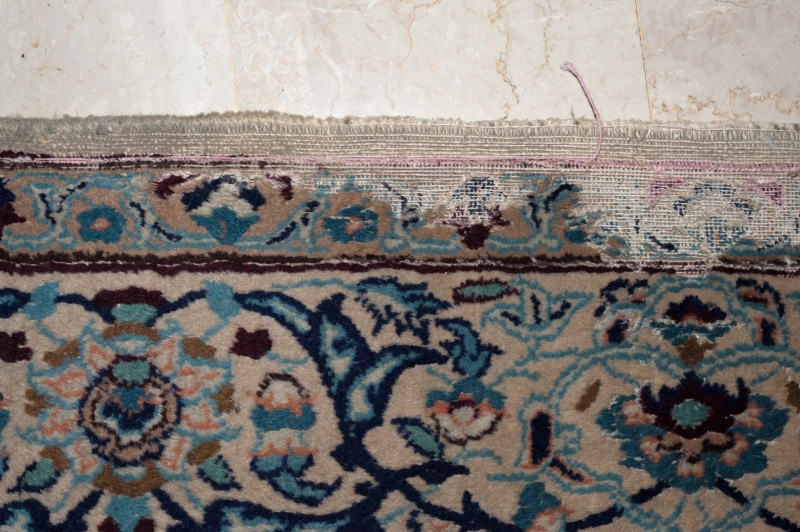 Carpet moth damage to a nain persian rug