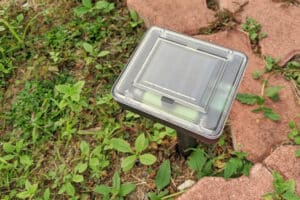 ultrasonic pest repeller for moles with a solar panel installed in a yard